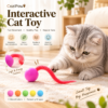 Gray cat playing with a CoziPaw fuzzy worm elastic ball toy indoors